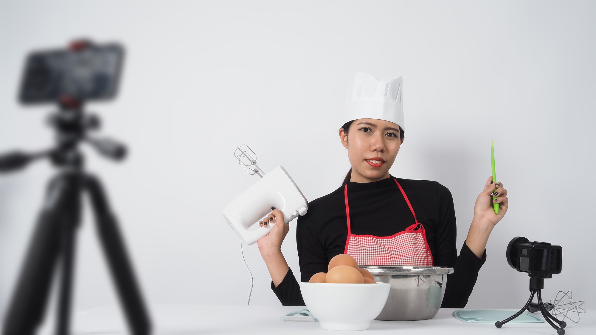 Studio kitchen with chef demonstrating technique